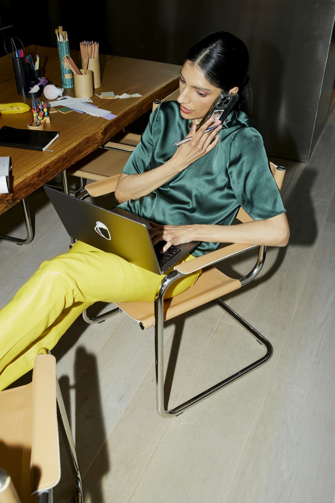 Business owner taking a call while working on a laptop